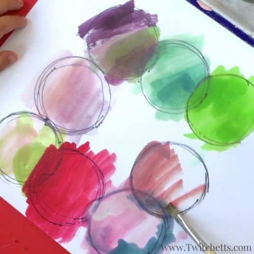 Create fidget spinner art by putting a pen in the hole and drawing circles. Add watercolors to make them vibrant and fun.