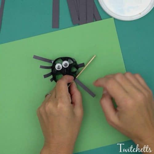Construction Paper quilling spiders using black construction paper.