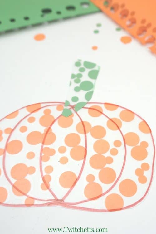 A simple pumpkin themed fine motor activity combines construction paper and contact paper to create a fun pumpkin craft. This activity for preschoolers is perfect for fall, Halloween, or Thanksgiving. Hang this pumpkin suncatcher in any window for a fun fall decor.