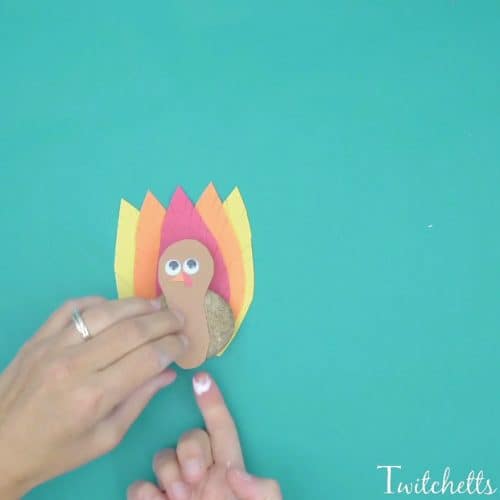 A turkey rock craft that is a cute and easy craft for kids.  This fun Thanksgiving craft combines rock decorating with construction paper to create an adorable turkey.