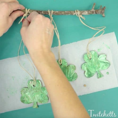 Create a beautiful pour painted shamrock. This one of a kind St Patrick's Day art project will make a fun decoration!