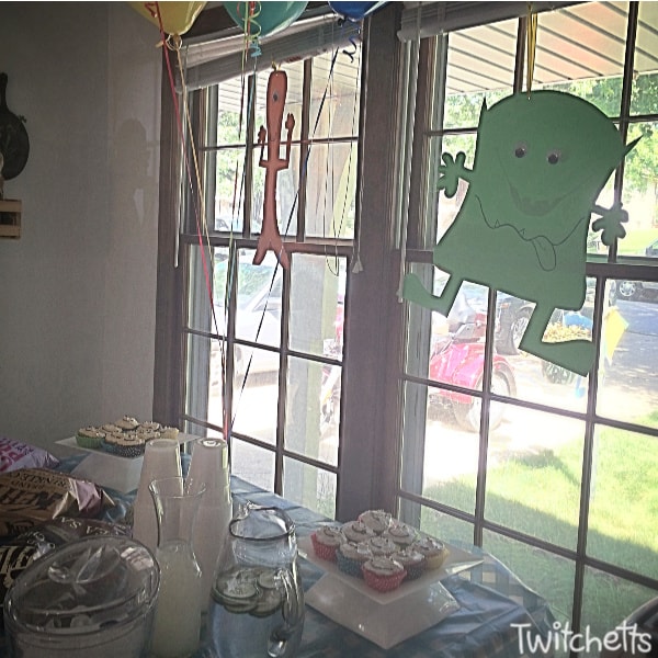 Monster themed birthday party that is perfect for a boys first birthday. Monster cake, plus monster decorations, and other monster themed first birthday ideas. #twitchetts