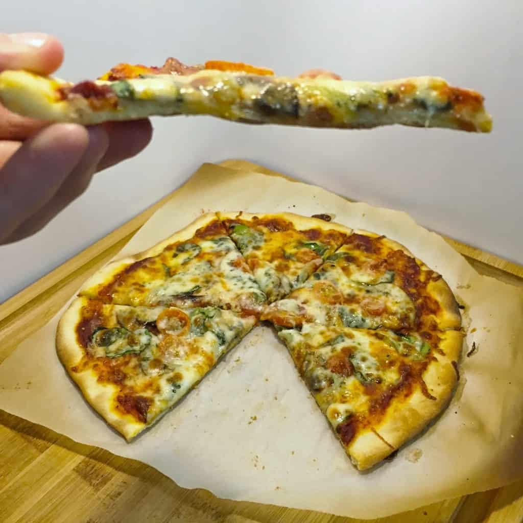 Learn the Secret to No Flop homemade Pizza Crust! This simple trick will have you make you a homemade pizza pro. Includes an easy pizza dough recipe too!