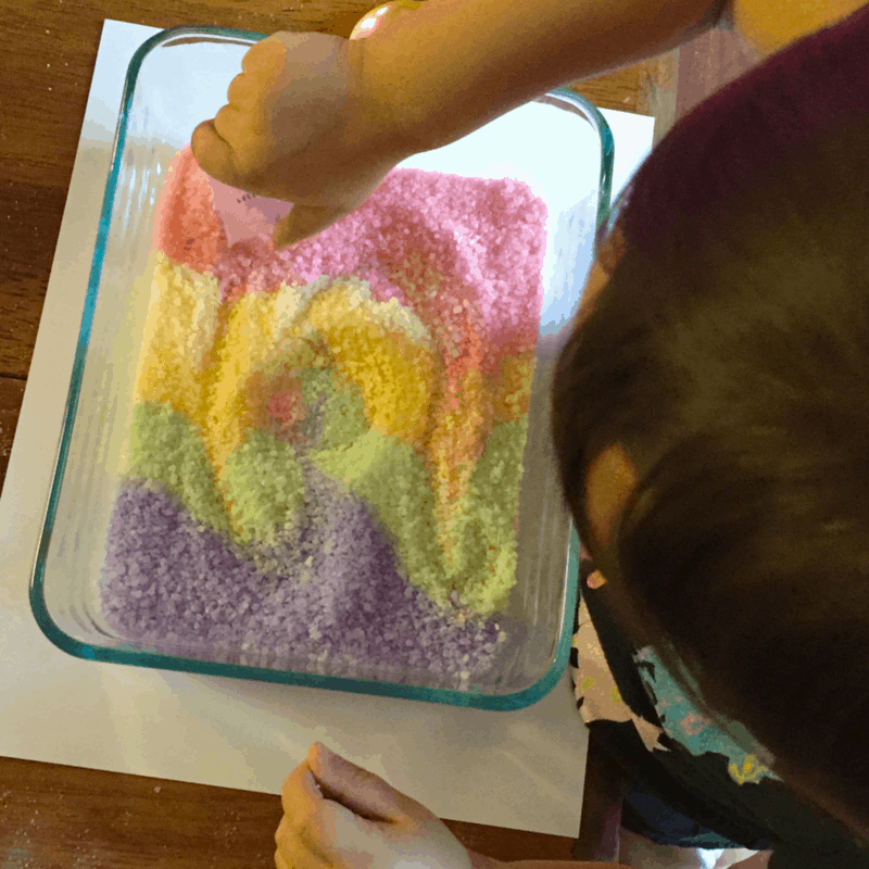 This fun colored salt can be used for sensory play or fun kids crafts. This is a quick toddler activity and the older kids enjoy playing in it too!!