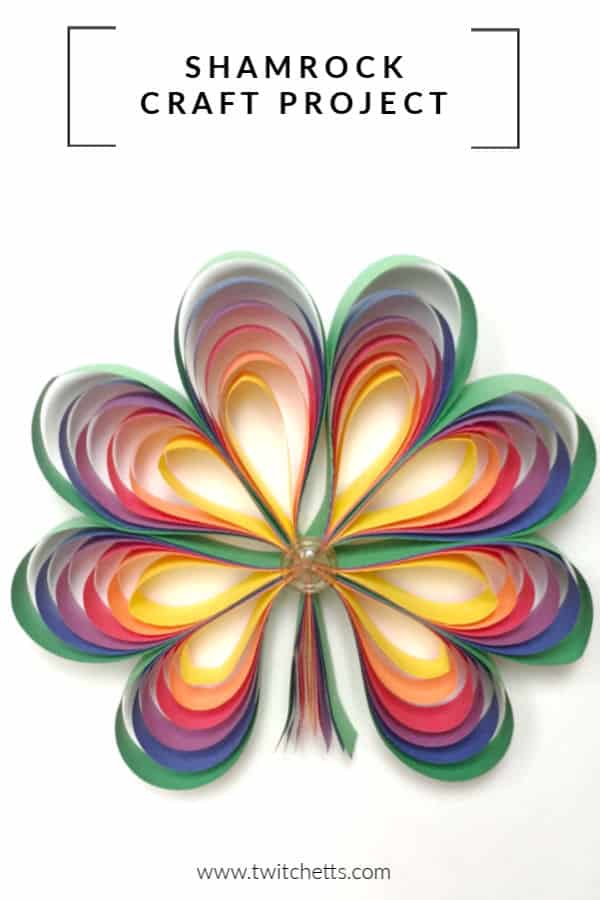 Rainbow colored paper shamrock craft for kids. Grab some construction paper and lets create this fun 3D St Patrick's Day craft. It's perfect for decorating for a St Patty's party! #twitchetts