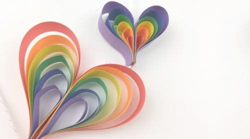 Create a spinning rainbow heart mobile using construction paper. Fun kids rainbow art project that is a perfect rainbow craft for preschoolers, kindergarteners, and kids of all ages!