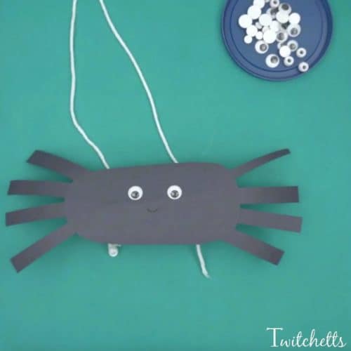 Create climbing construction papers spiders using black construction paper. A fun Halloween kids craft that they can play with when they're finished!