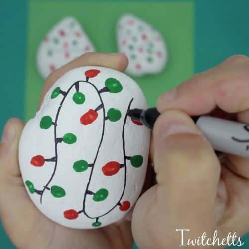 This Christmas lights rock art is easy, fun, and a perfect painted rock to give as a gift or hide in your nearest park.