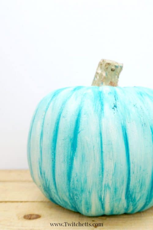Fun teal painted plastic pumpkin to place on your porch this Halloween season. The first of this year's teal pumpkin ideas! #teal #pumpkin #decor #paintedpumpkin #paintedplastic #plasticpumpkin #inexpensivedecor #falldecor #halloween #twitchetts