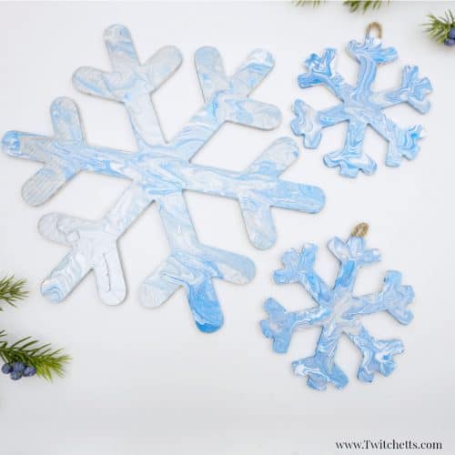 These pour painted snowflake decorations are the perfect winter art project for kids.