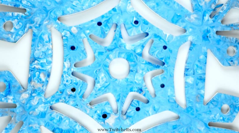 Create press painting snowflake decorations. This creative painting technique is a fun way enjoy painting with kids.