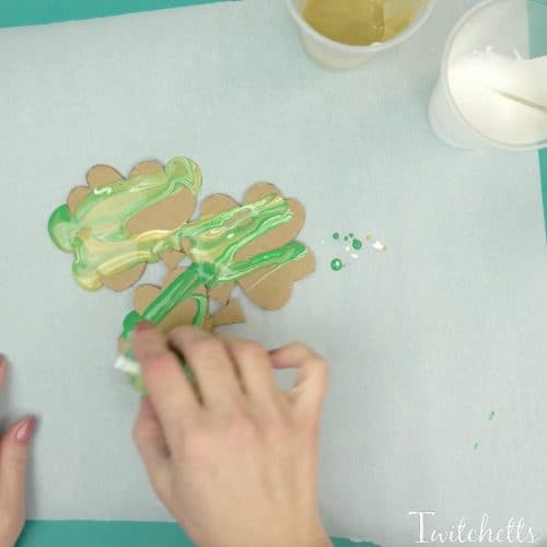 Create a beautiful pour painted shamrock. This one of a kind St Patrick's Day art project will make a fun decoration!