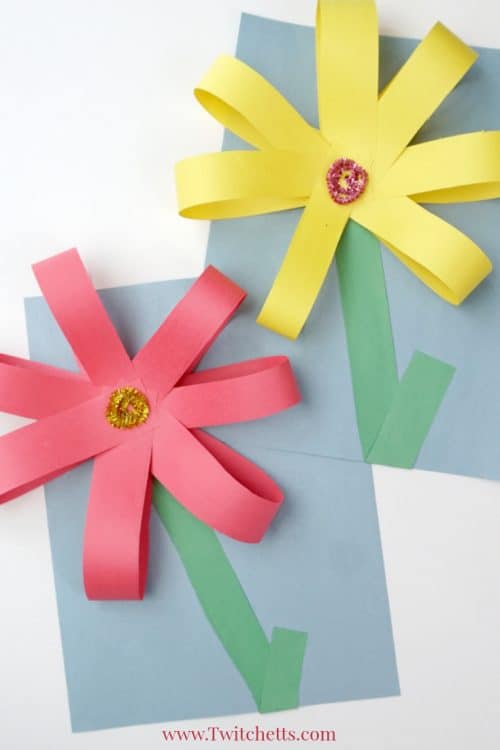 Create giant paper flowers with simple supplies and fine motor skills. Your kids will be proud of this fun construction paper craft! #giantpaperflowers #constructionpaperflowers #papercraftflowers #giantflowers #largecrafts #constructionpapercraftsforkids #finemotorskills #preschoolcrafts #springcrafts #twitchetts