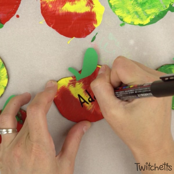 This apple themed press painted garland is so much fun to make! Apples are the perfect way to decorate a classroom for back to school or your living room for fall. Plus your kids will love that can help make them!