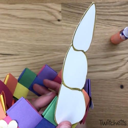 Create a fun unicorn crown using construction paper. Your child will love wearing this paper crown while pretending to be a unicorn. #unicorn #unicorncrown #unicorncraft #paperunicorn #diyunicorn #dressup #costume #makebelieve #kidscraft #constructionpaper #twitchetts