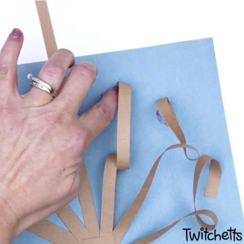 Create fun 3d Valentine's Day paper trees using a simple kid-friendly technique that is guaranteed to wow! This construction paper craft is perfect for a classroom craft or a winter afternoon activity. It's fun for kids of all ages! #twitchetts