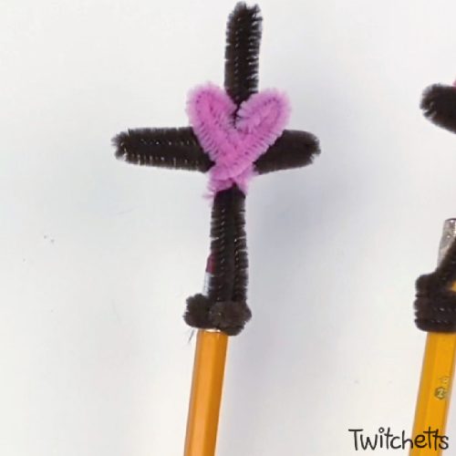 Image of a cross pencil topper made with pipe cleaners.
