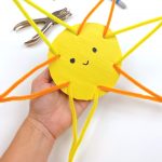 Sun Craft made with pipe cleansers, cardboard, and construction paper. Text Reads: "Summer Craft - Happy Sun"
