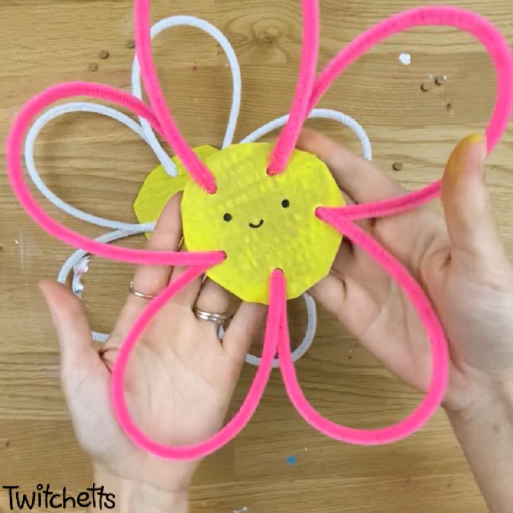 In process image of a flower made with cardboard and pipe cleaners.