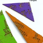 Cardboard triangles painted in secondary colors. Text reads: "Preschool Craft - Triangles"