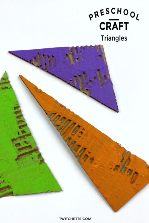 Cardboard triangles painted in secondary colors. Text reads: "Preschool Craft - Triangles"