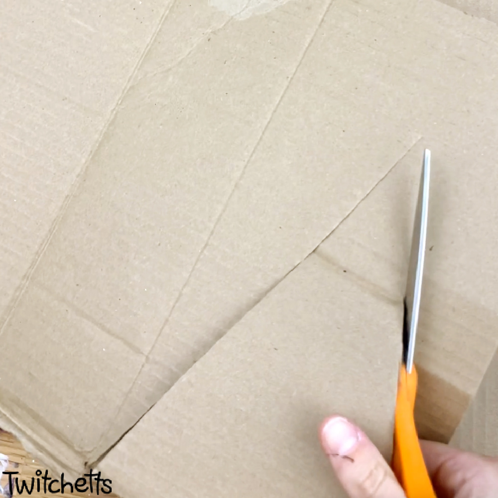 In process image of a cardboard triangle craft for preschoolers.