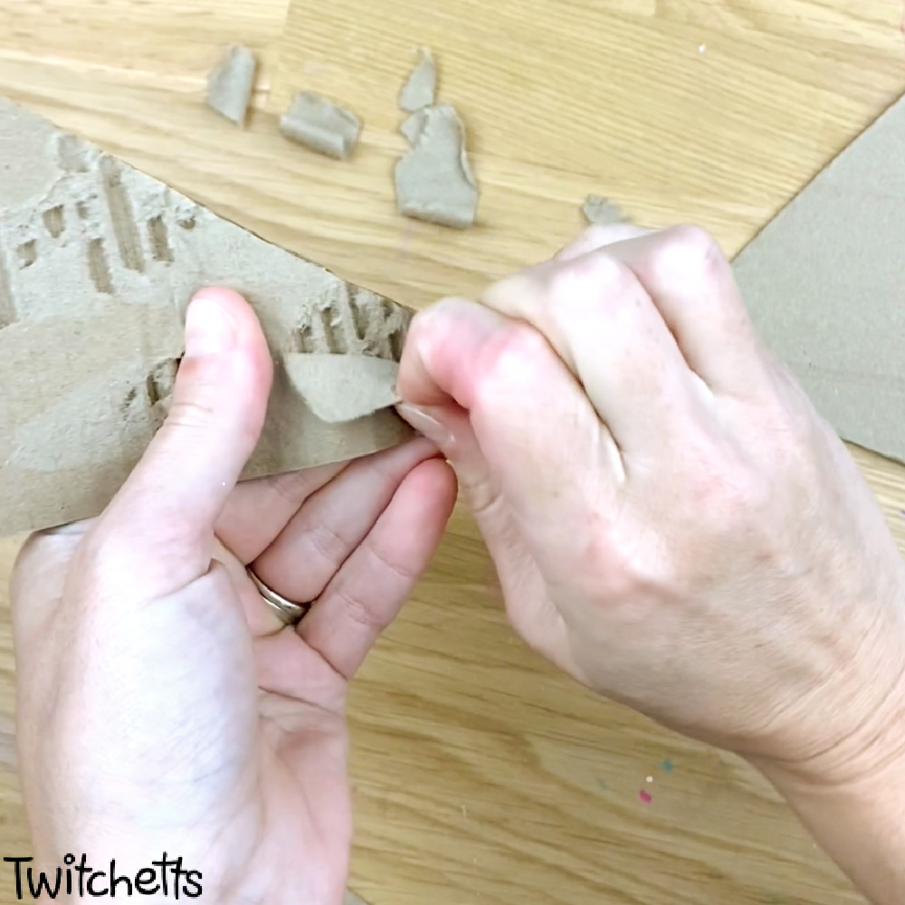 In process image of a cardboard triangle craft for preschoolers.