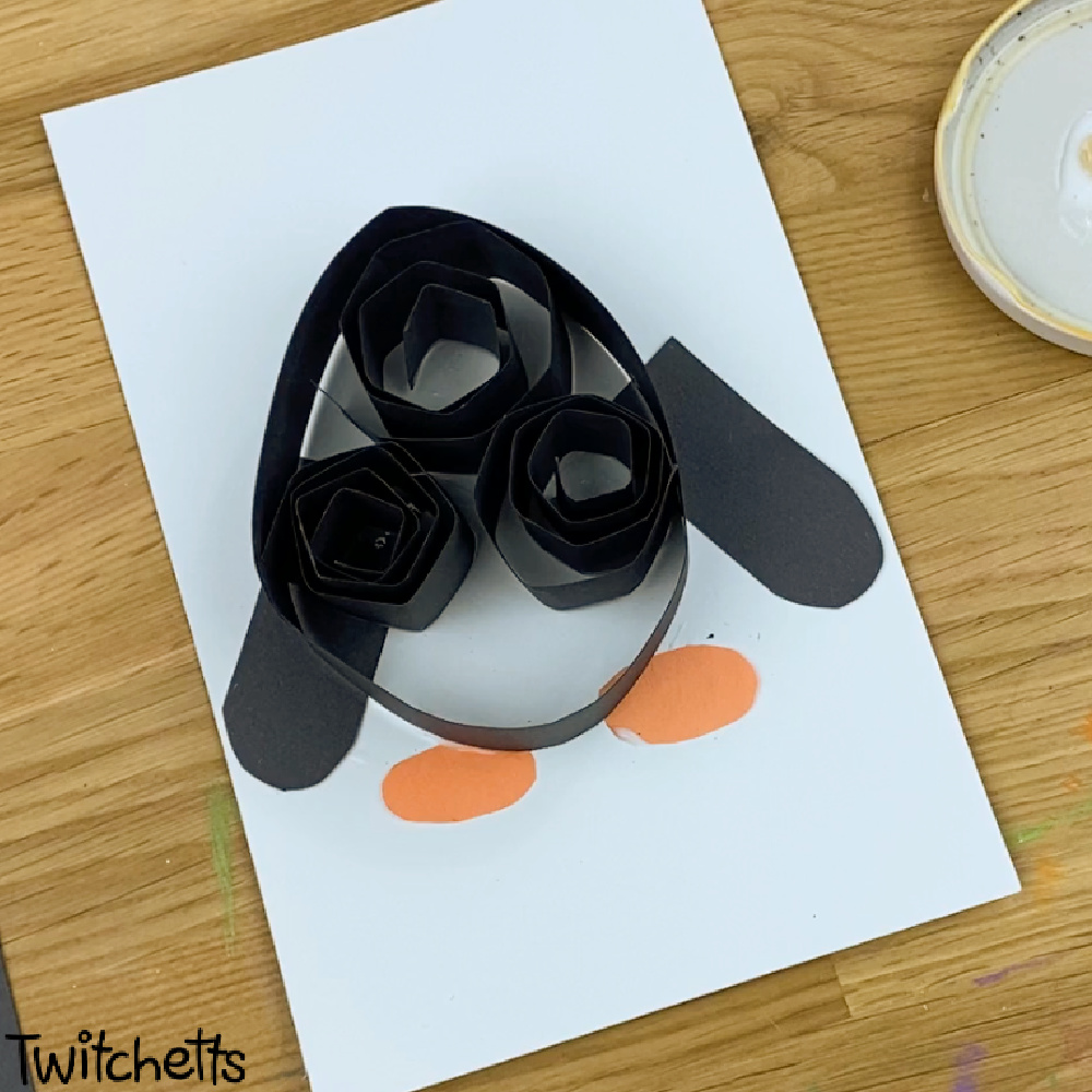 In process image of a paper penguin craft