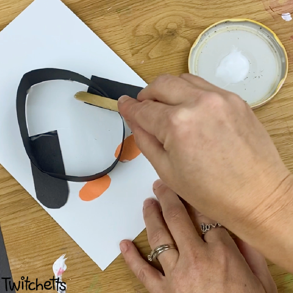 In process image of a paper penguin craft