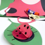 paper ladybug craft. Text reads "Construction Paper Ladybugs"