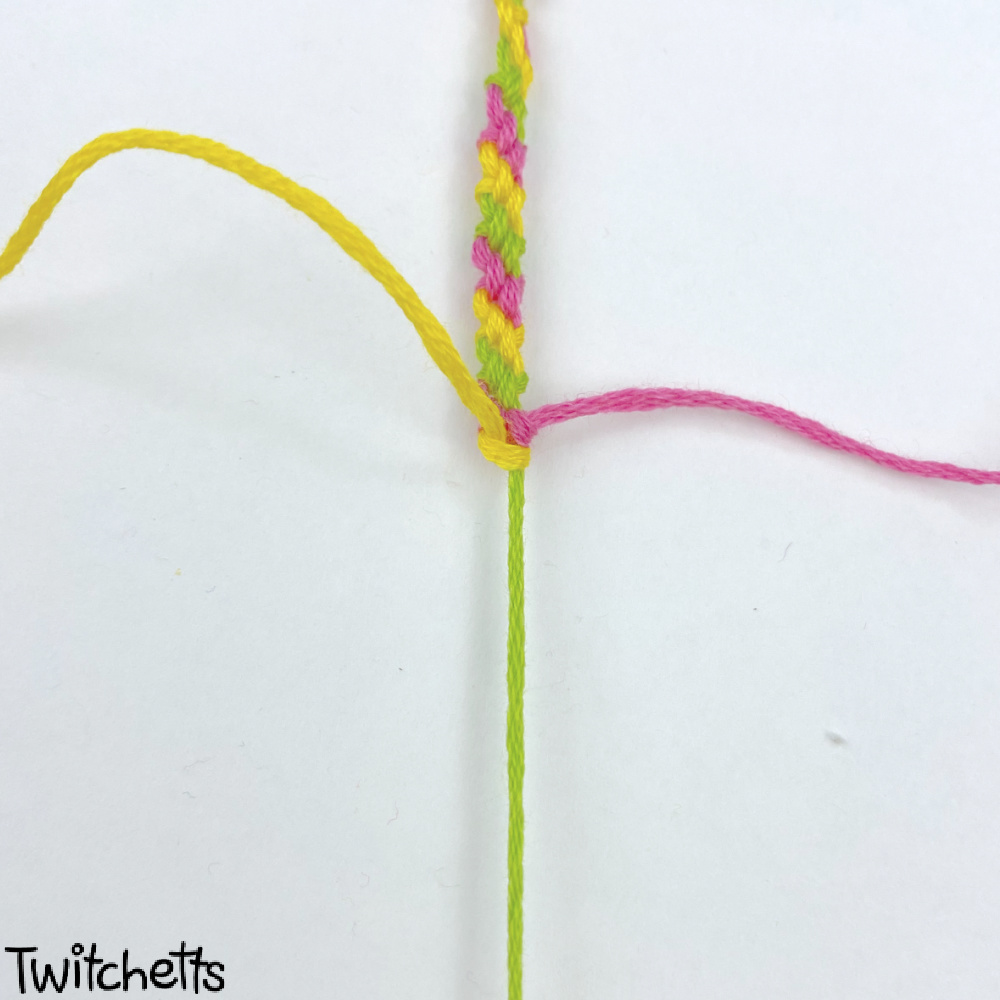 In process image of a candy stripe friendship bracelet