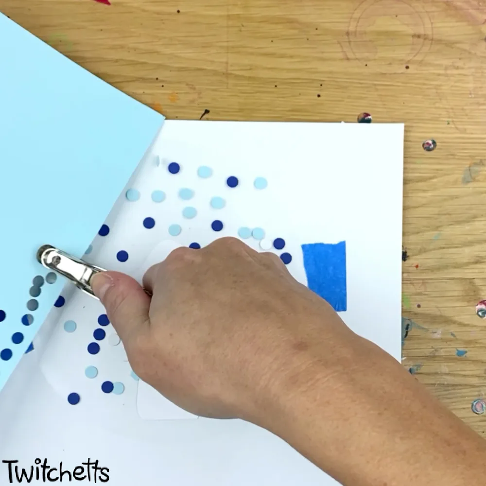 In process image of a paper snow globe craft.
