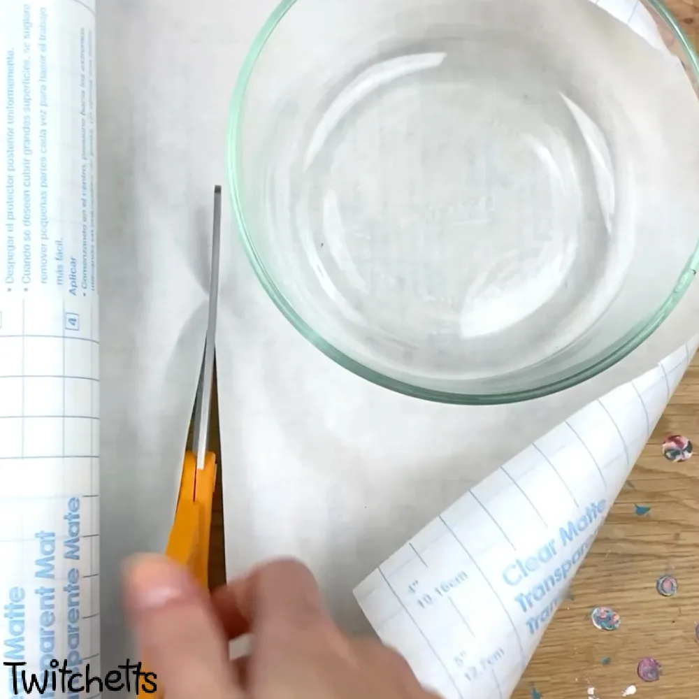 In process image of a paper snow globe craft.