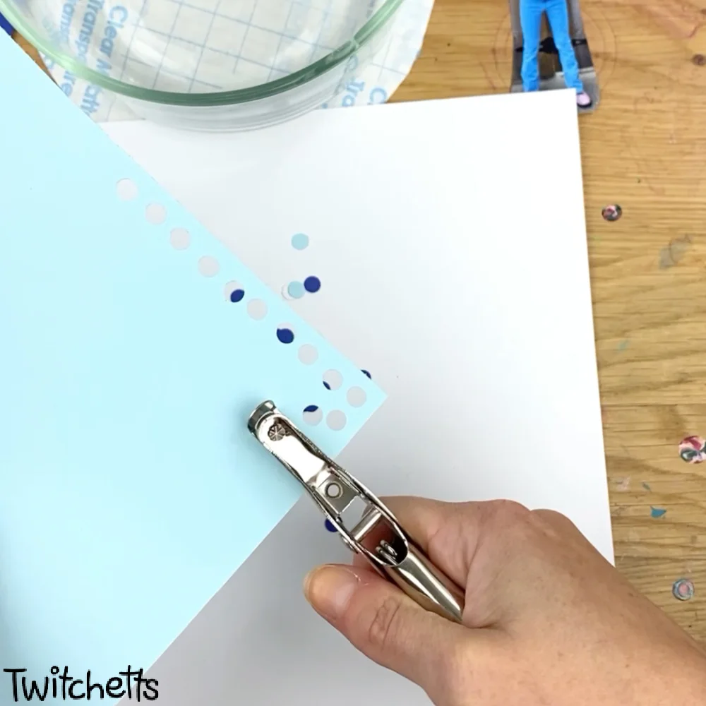 In process image of a paper snow globe craft.