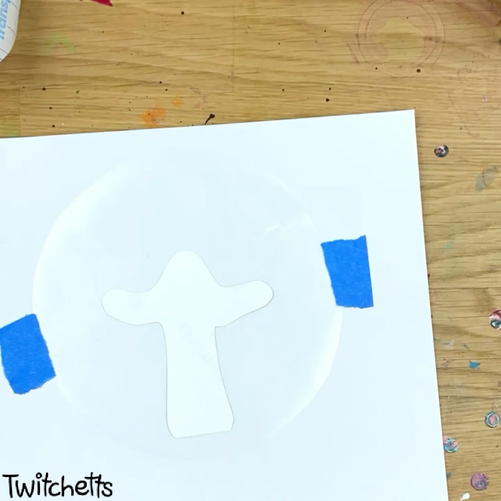 In process image of a paper snow globe craft.