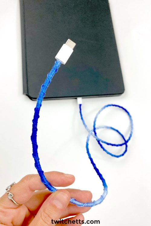 A charging cord wrapped in embroidery thread.